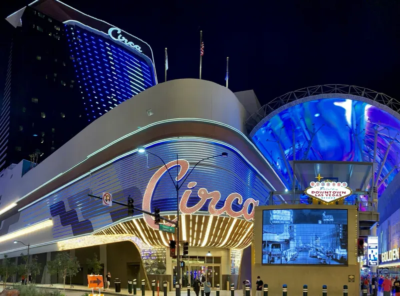 Circa Resort & Casino lit at night on Fremont Street, its marquee and hotel tower beside the Fremont Street canopy